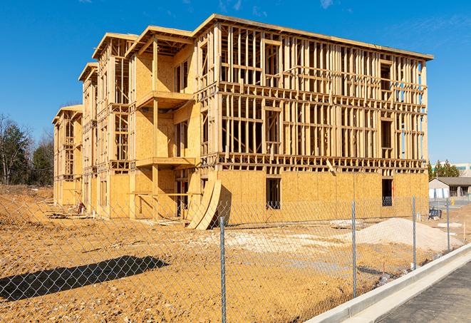 a temporary chain link fence locking away a building under renovation, serving as a security tool in Imperial Beach